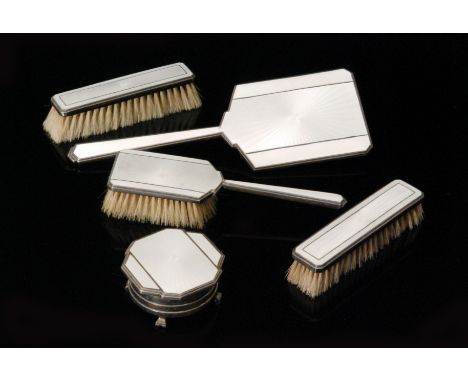 An Art Deco hallmarked silver and white guilloche enamel five piece dressing table set comprising of a hair brush, two hand b