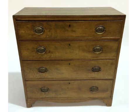 A George IV mahogany chest of four long drawers, with cock-beaded drawer fronts and applied brass handles, raised to bracket 