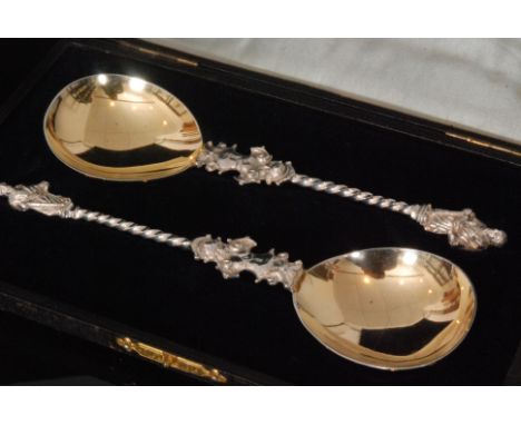 A pair of late Victorian hallmarked silver apostle spoons, each with spiral twist stem above cast Renaissance style putti, te