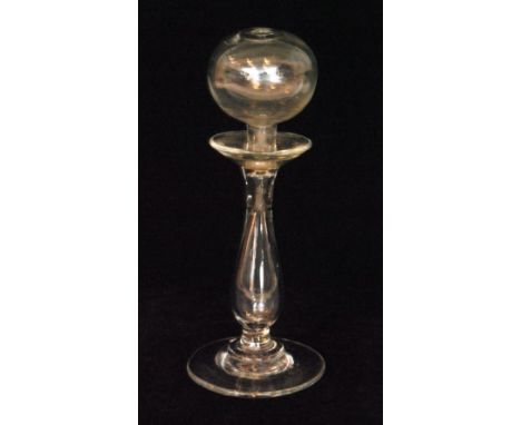 A 19th Century lace makers lamp with a wide circular spread foot rising to a hollow blown baluster form stem with spherical o