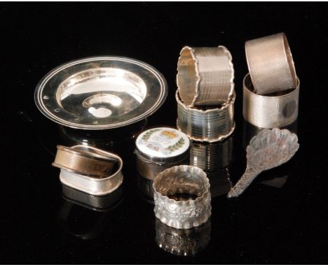 A small parcel lot of assorted silver to include seven napkin rings, a modern caddy spoon, an enamelled silver jubilee pill b