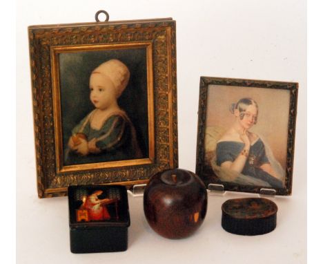 A 20th Century Russian papier mache snuff box the cover painted with a lady seated at a desk and working on a piece of cloth 