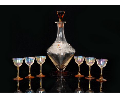 An early 20th Century decanter set comprising a conical decanter with orange foot and stopper decorated to the body with an a