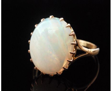 An early 20th Century 15ct single stone oval opal ring, claw set stone, length approximately 15mm, to split shoulders, ring s