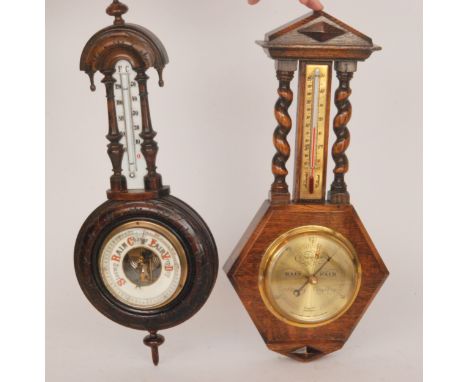 A Victorian carved walnut aneroid barometer and a similar oak cased barometer (2)