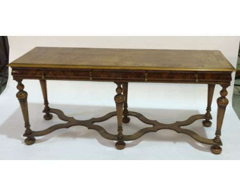 A walnut veneerer buffet in the mid 18th Century style, fitted with two frieze drawers over six faceted and tapered legs unit