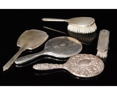 A hallmarked silver three piece brush set with engine turned decoration to whole, together with two hallmarked silver backed 
