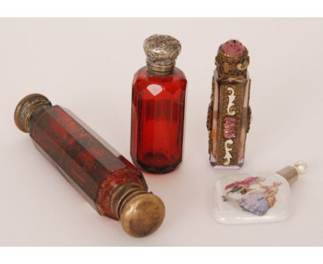 A Victorian ruby glass double ended scent bottle, the faceted cylindrical glass body terminating in hinged caps, length 12.5c