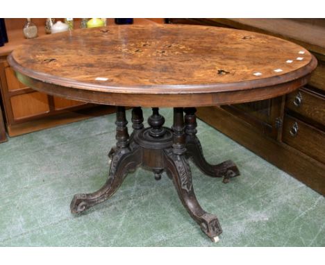 A Victorian burr walnut tilt-top centre table, quarter veneered top inlaid with satinwood and boxwood swags and flora, four t