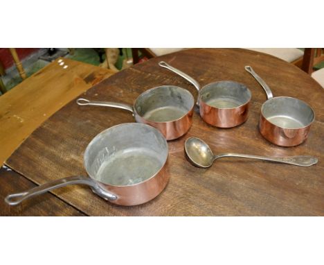 A set of four graduated copper pans; a silver coloured metal ladle (5)