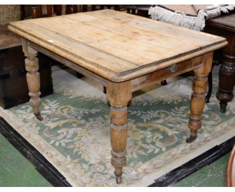 A Victorian pine country kitchen table, plank top, single drawer to frieze, turned supports, ceramic casters. 75cm high x 118