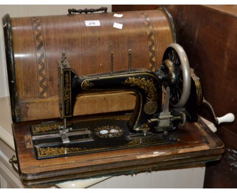 A vintage Gebr Nothmann hand powered sewing machine in Tunbridgeware case.