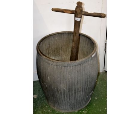 A vintage galvanized dolly tub and a washing dolly. (2)