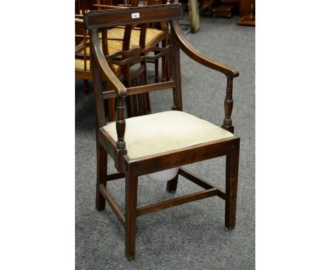 A George III mahogany commode chair.