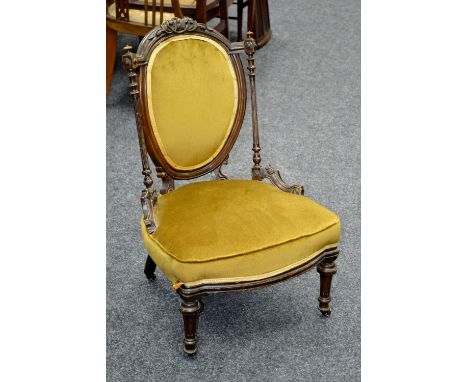 A Victorian mahogany nursing chair, oval padded back, turned and fluted uprights, padded seat, turned tapering forelegs, cera