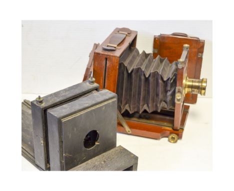 A Mahogany and Brass Field Camera, circa 1890 with focusing screen and double dark slide and wooden enlarger.