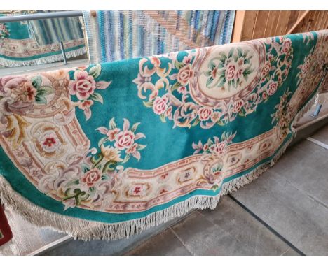 An oval Chinese wool carpet, blue ground, decorated with flowers, 280cm x 200cm (approx).Condition:- Good overall condition, 