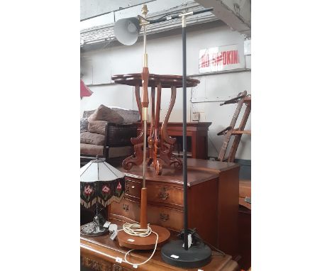 A retro teak and brass standard lamp and a black metal and brass floor standing lamp.