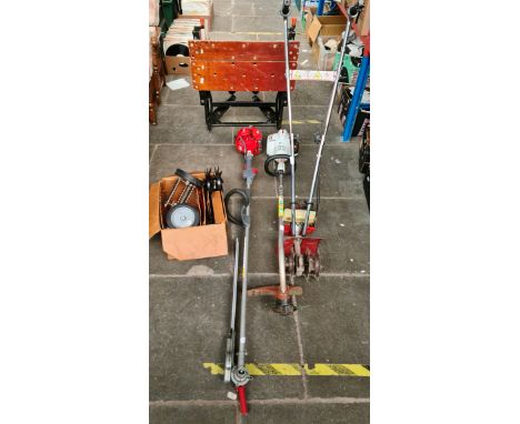 A petrol strimmer, a rotovator with tools, a petrol lopper and a Black and Decker work bench.