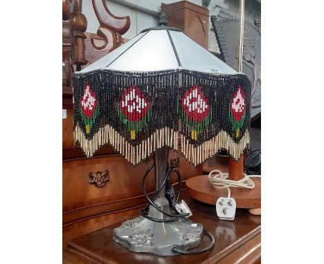 A Tiffany style gypsy lamp on cast base.