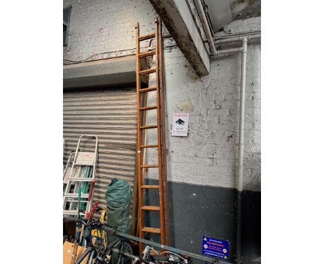 An extending wooden ladder  