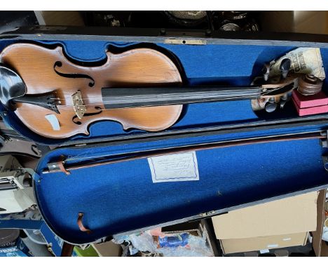 An antique 2 back piece violin in hard ebonised case with bow.  Bears Stradivarius label.