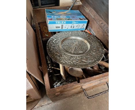 A vintage toolbox with various tools and a vintage flying headset  