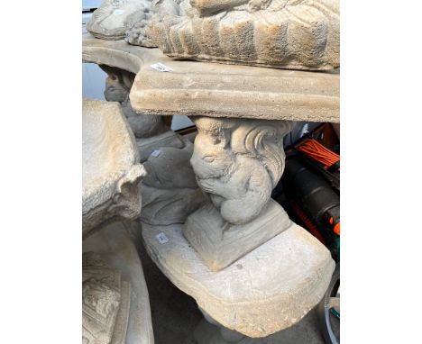 A curved concrete bench on squirrel shaped plinths  