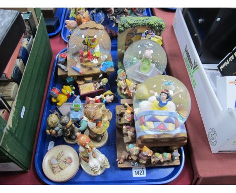 Two Snow White and One Pinocchio snow globes, having musical facility, four Hummel figures, etc:- One Tray.
