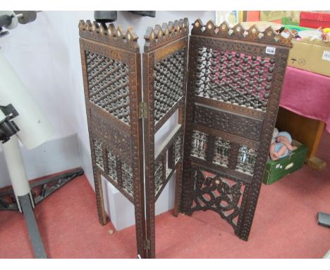 A Middle Eastern Stained Softwood Folding Screen, with mother of pearl insets and lattice work to three panels, 100cm high (d