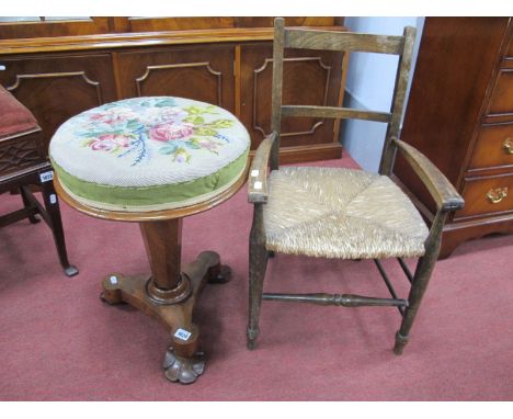 A XIX Century Mahogany Revolving Piano Stool, with circular tapestry top tapering octagonal support on triform base having pa