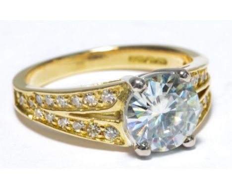 An 18ct yellow gold moissanite and diamond set ring, the central 2ct moissanite with tiny diamonds to the shoulders, size K, 