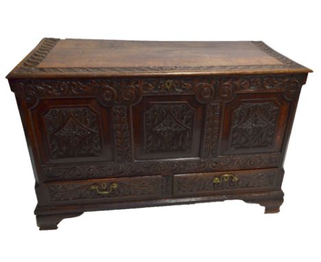 A George III oak coffer, later carved at the Macclesfield School of Carving, with two drawers above ogee bracket feet, width 