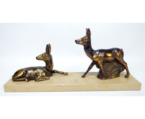 An Art Deco style French ornament modelled as two gazelles on a rectangular plinth, length 35cm.