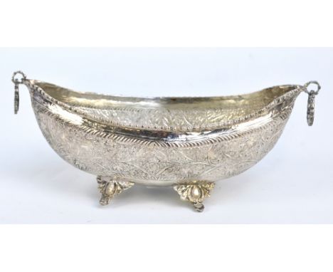 A circa 1900 Persian white metal boat shaped bowl with twin ring handles, on four cast supports, length 18.5cm, approx 4ozt.