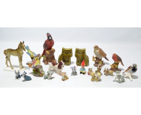 A group of six ceramic figures of birds, a further Beswick matt glazed dog, a German manufacture horse, a circa 1970s green g