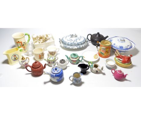 A collection of mixed ceramics to include a number of small teapots and jugs in various styles and forms to include a black b