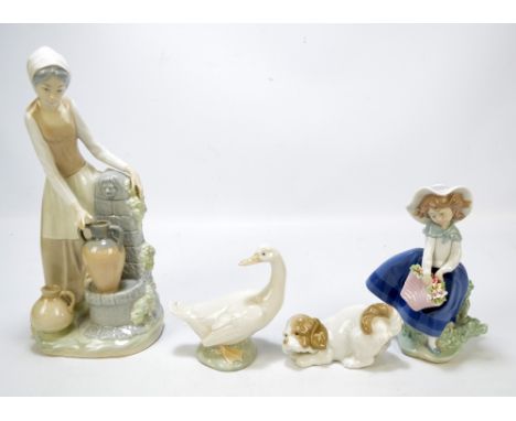 A Lladro figure of a young girl holding a basket of flowers, a large Nao figure of a young woman beside a well, a Nao figure 