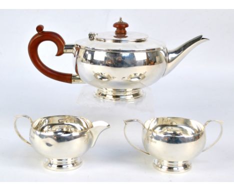 G BRYAN & CO; a George VI hallmarked silver three piece tea service, comprising teapot of squat circular form with C-scroll h