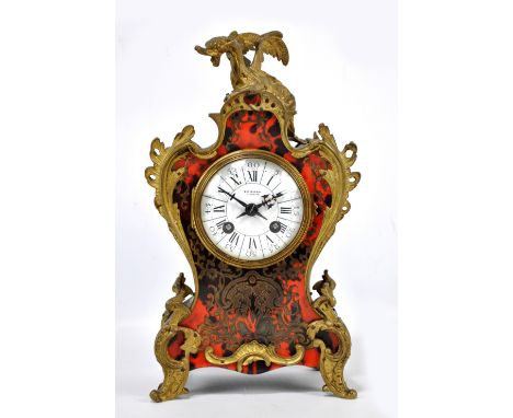 A late 19th century French Boulle work mantel clock with shaped case surmounted by a dragon above white enamel dial set with 