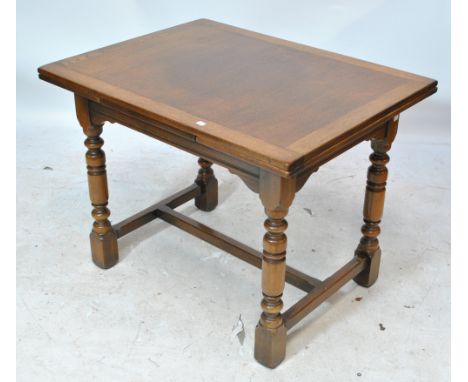 GOMME; a reproduction oak rectangular table on ring turned supports to block feet, length 98.5cm.