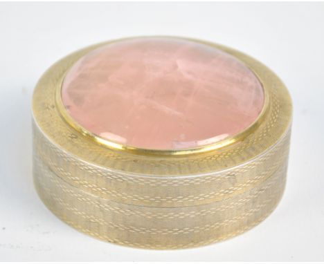 SAMPSON MORDAN & CO; a George V hallmarked silver gilt circular box with overall engine turned decoration, set with pink quar