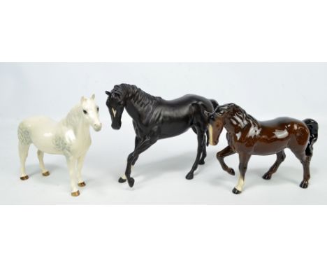 Three ceramic model horses to include two Beswick examples, one in dappled grey and stamped to base Connemara (3).