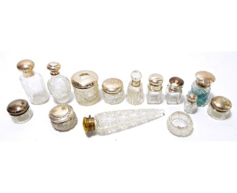 A collection of hallmarked silver topped and hallmarked silver mounted glass, scent and dressing table jars and bottles inclu