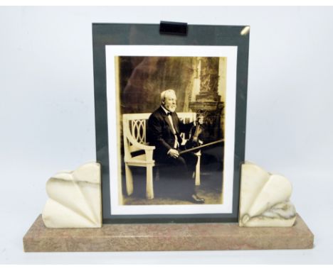 An Art Deco style French marble mounted photograph frame raised on rectangular plinth, width 34.5cm. CONDITION REPORT: Genera