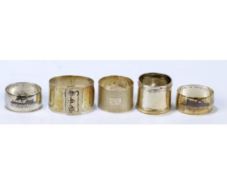 A pair of Iraqi white metal niello decorated napkin rings, a hallmarked silver engine turned decorated example, Sheffield 195