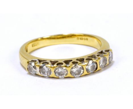 An 18ct yellow gold dress ring, set with seven round cut diamonds, size L, approx 3.2g.