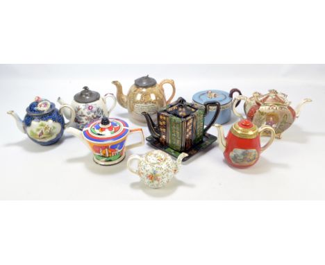 A group of nine ceramic teapots of varied size and form to include a circular Sadler example in the style of Clarice Cliff, u