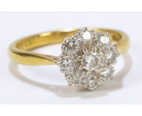 An 18ct yellow gold diamond set floral cluster ring, size O, approx 3.9g. CONDITION REPORT: Stones with numerous inclusions a