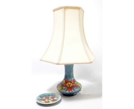 MOORCROFT; a pale blue ground 'Columbine' pattern tube line decorated lamp base, and a small Moorcroft 'Columbine' pin dish (